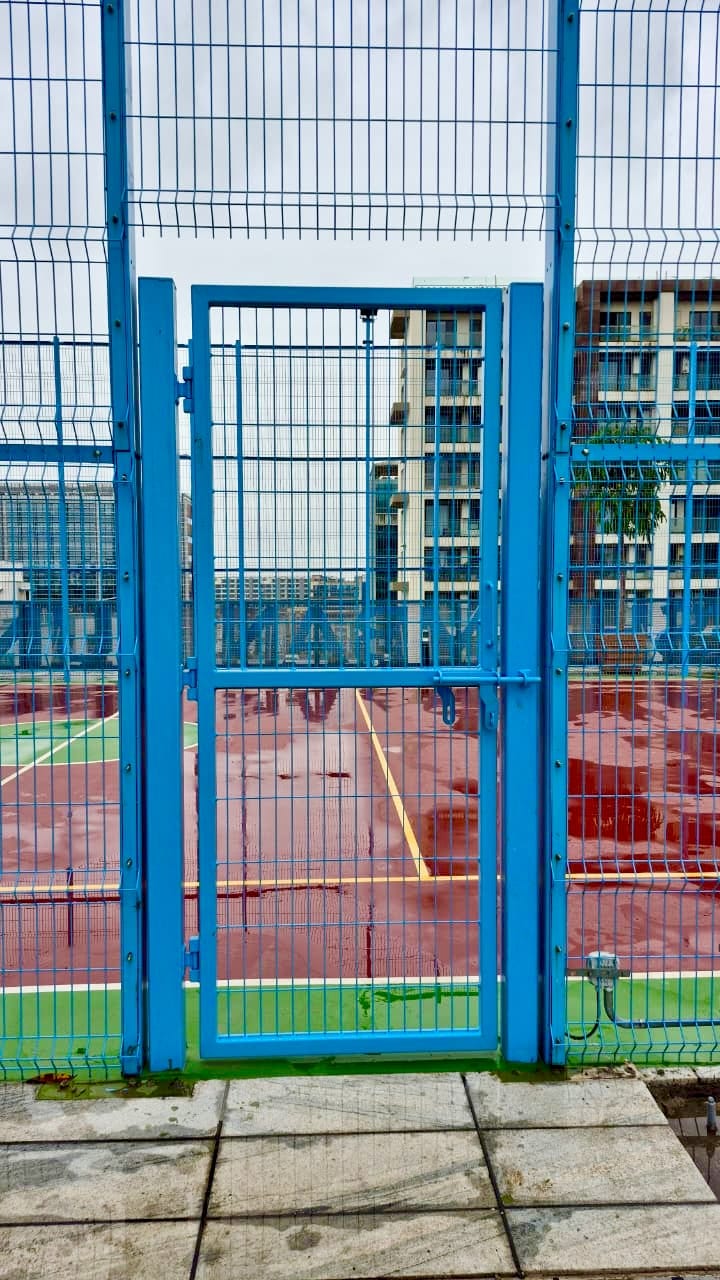 Blue powder-coated welded mesh access door with heavy-duty latch mechanism