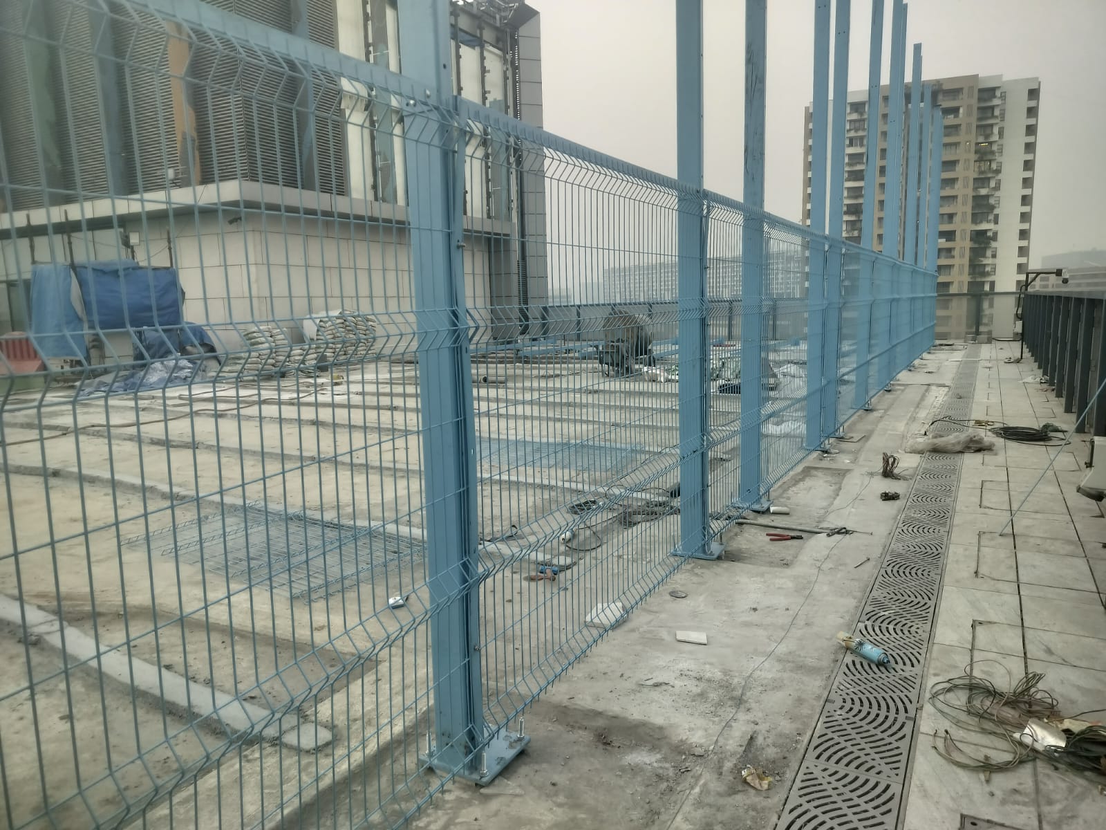 Erection of blue powder-coated structural steel posts