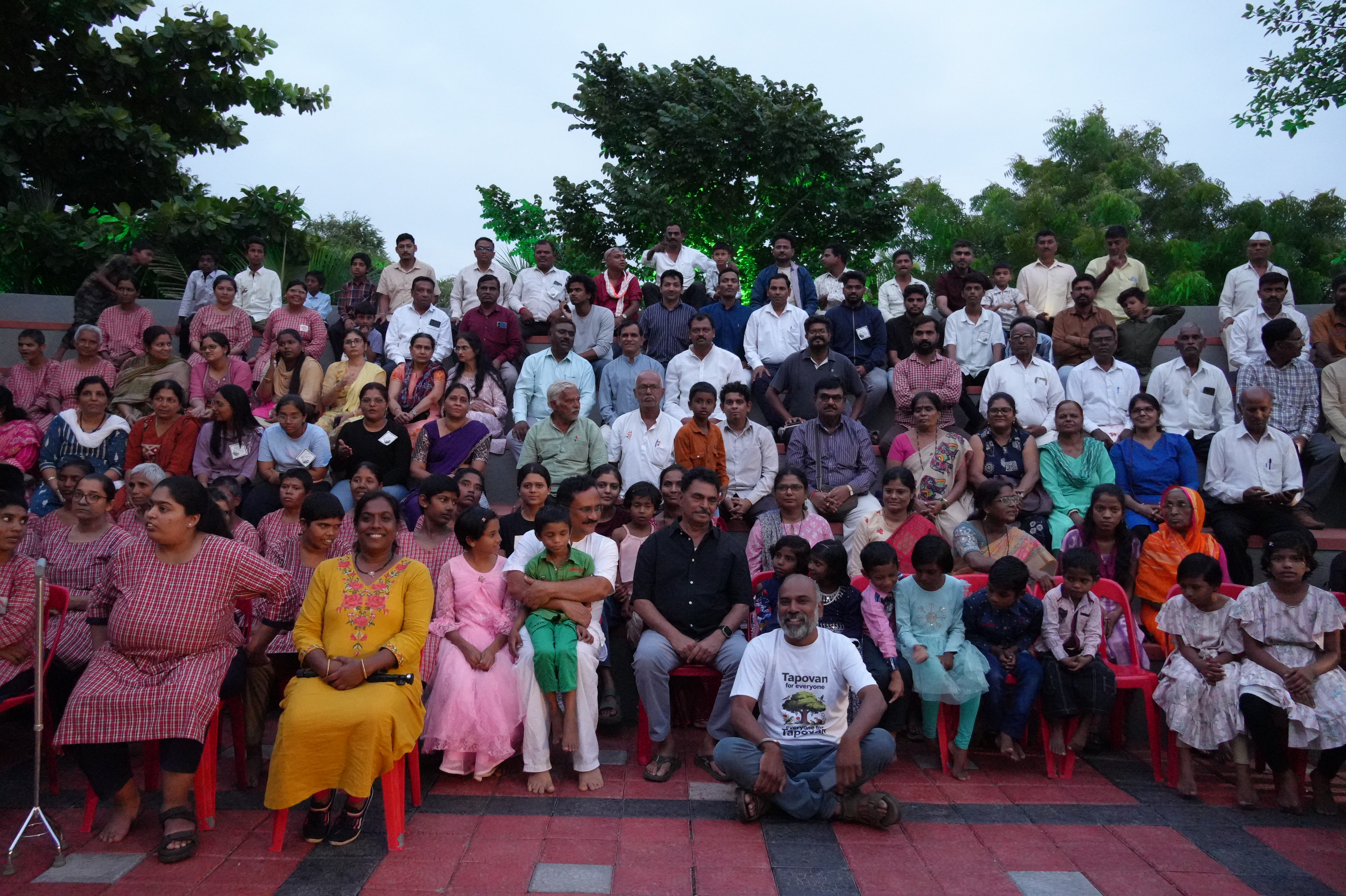Attendees seated in open grounds